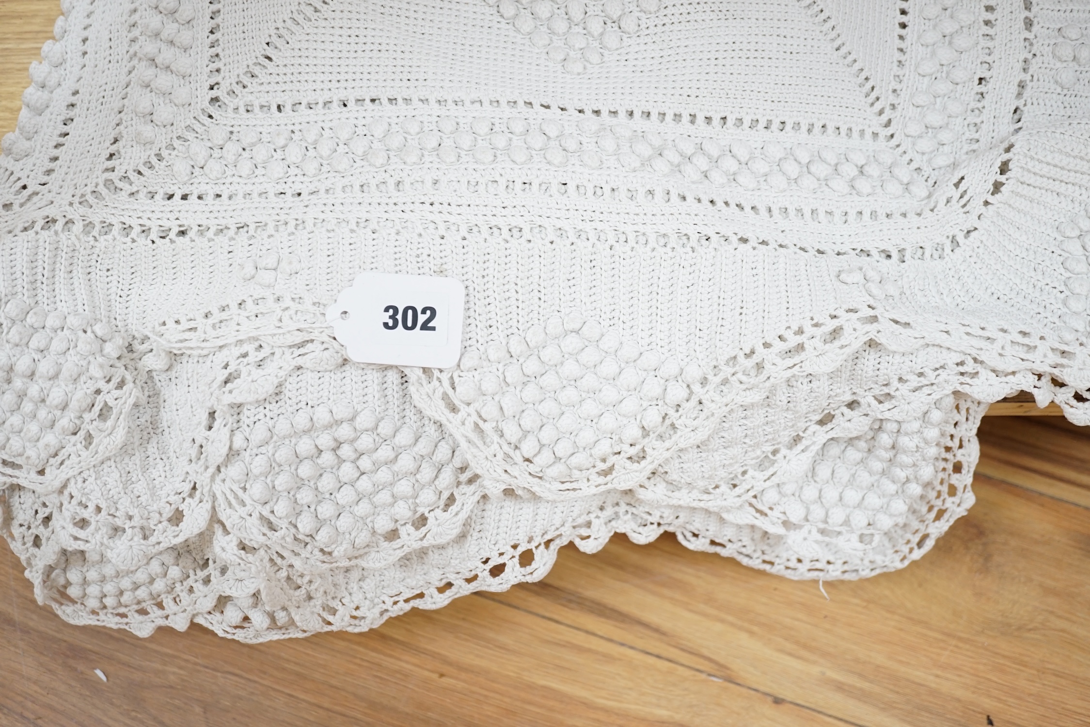 An early 20th century French knitted and crocheted bedcover with bobble motifs, 220cm x 200cm